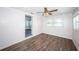 Living room with large windows, wood-look tile floors, and ceiling fan at 1536 77Th N Ave, St Petersburg, FL 33702