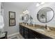 Modern bathroom with double vanity, round mirrors, and shiplap walls at 19218 Alexandrea Lee Ct, Land O Lakes, FL 34638