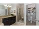 Modern bathroom featuring granite countertops, dark wood cabinetry, and a walk-in shower at 19218 Alexandrea Lee Ct, Land O Lakes, FL 34638