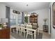 Dining room with large table, white chairs, and decorative hutch at 19218 Alexandrea Lee Ct, Land O Lakes, FL 34638