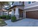 Front exterior of a two-story home with a covered entryway and a double garage at 19218 Alexandrea Lee Ct, Land O Lakes, FL 34638