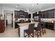 Modern kitchen with dark wood cabinetry, a large island with bar seating, and stainless steel appliances at 19218 Alexandrea Lee Ct, Land O Lakes, FL 34638