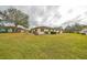 Spacious backyard with a large lawn, perfect for outdoor activities at 2003 Halmrock Pl, Sun City Center, FL 33573