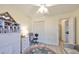 Bedroom with white storage, ceiling fan, and a chair at 2003 Halmrock Pl, Sun City Center, FL 33573