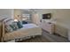Bedroom featuring a comfortable bed, dresser, and TV, creating a relaxing atmosphere at 2003 Halmrock Pl, Sun City Center, FL 33573