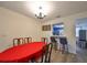 Dining room with red tablecloth, breakfast bar pass-through to kitchen at 2003 Halmrock Pl, Sun City Center, FL 33573