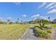 Scenic park with a gazebo and walking path amidst green lawns and palm trees at 2003 Halmrock Pl, Sun City Center, FL 33573