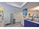Kitchen with blue and white cabinets, double sink, and view to living area at 2003 Halmrock Pl, Sun City Center, FL 33573