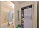 Bathroom with laundry area featuring a stacked washer and dryer at 2003 Halmrock Pl, Sun City Center, FL 33573