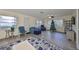 Living area with wood floors, Christmas decor, comfy chairs, and large windows at 2003 Halmrock Pl, Sun City Center, FL 33573