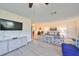 Living room with wood-look flooring, comfy furniture, and a large TV at 2003 Halmrock Pl, Sun City Center, FL 33573