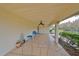 Covered patio with seating, decorative plants, and view of the water at 2003 Halmrock Pl, Sun City Center, FL 33573