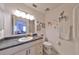 Clean and bright bathroom with white cabinetry and dark countertop at 2310 Gainesborough Loop, Sun City Center, FL 33573