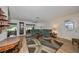 Living room featuring a grandfather clock, dining area, and access to another room at 2310 Gainesborough Loop, Sun City Center, FL 33573