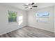 Well-lit bedroom with wood-look tile flooring and a ceiling fan at 2461 61St N Ln, St Petersburg, FL 33710