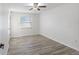 Spacious bedroom with wood-look tile flooring and ample natural light at 2461 61St N Ln, St Petersburg, FL 33710