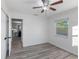 Bedroom with wood-look tile flooring, ceiling fan, and access to the living area at 2461 61St N Ln, St Petersburg, FL 33710