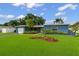 A well-maintained home featuring a lush lawn and vibrant landscaping at 2461 61St N Ln, St Petersburg, FL 33710
