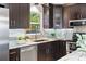 Well-appointed kitchen featuring dark wood cabinets, stainless steel appliances, and sleek countertops at 2461 61St N Ln, St Petersburg, FL 33710