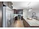 Stylish kitchen with dark cabinetry, stainless steel appliances, and a large island at 2461 61St N Ln, St Petersburg, FL 33710