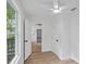 Bright bedroom with wood-look floors, white walls, and a view into another room at 3407 E 24Th Ave, Tampa, FL 33605