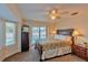 Primary bedroom with pool access and comfortable king-size bed at 411 Belle Isle Ave, Belleair Beach, FL 33786