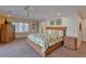 Main bedroom with king bed, ceiling fan, and wooden dresser at 411 Belle Isle Ave, Belleair Beach, FL 33786