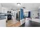 Modern kitchen featuring white cabinets, black appliances, and an adjacent dining area at 5047 Fitchburg Dr, Holiday, FL 34690