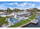 An aerial view showcases a stunning waterfront property with a pool and dock at 5101 Huntington Ne Cir, St Petersburg, FL 33703