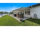 Charming back patio with dining set and stylish outdoor decor overlooking the waterfront with a retractable awning at 5101 Huntington Ne Cir, St Petersburg, FL 33703