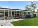 Inviting back patio area with comfortable seating, awning, and well-maintained landscaping creating an outdoor living space at 5101 Huntington Ne Cir, St Petersburg, FL 33703