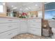 Bathroom featuring white cabinetry, tiled walls, and patterned tile flooring at 5101 Huntington Ne Cir, St Petersburg, FL 33703