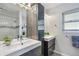 Modern bathroom with double sink vanity, sleek mirror, and a view of the shower at 5101 Huntington Ne Cir, St Petersburg, FL 33703