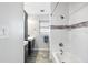 Modern bathroom featuring dark wood vanity, white tile and shower/tub combo at 5101 Huntington Ne Cir, St Petersburg, FL 33703