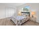 Bright bedroom with patterned bed, matching side tables with lamps, and a closet space at 5101 Huntington Ne Cir, St Petersburg, FL 33703