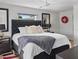 Bedroom with tufted headboard, wood-look floors, and ample natural light at 5101 Huntington Ne Cir, St Petersburg, FL 33703