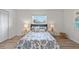 Cozy bedroom featuring a bed with patterned bedding, complemented by matching side tables and lamps at 5101 Huntington Ne Cir, St Petersburg, FL 33703