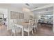 Dining area features a modern chandelier, wood floors, and seating for six at 5101 Huntington Ne Cir, St Petersburg, FL 33703