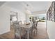 Bright dining area features chandelier, seating for six, and an adjacent view into the kitchen at 5101 Huntington Ne Cir, St Petersburg, FL 33703