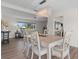 Bright dining room features modern light fixture, seating for six, and wood flooring at 5101 Huntington Ne Cir, St Petersburg, FL 33703