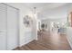 Bright foyer leading to an open-concept living area with stylish decor and wood-look flooring at 5101 Huntington Ne Cir, St Petersburg, FL 33703
