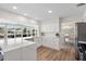 Bright kitchen with white cabinets, quartz countertops, stainless steel appliances and view of waterfront canal at 5101 Huntington Ne Cir, St Petersburg, FL 33703