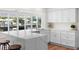 Modern kitchen featuring white cabinetry, a center island, and views of the waterfront at 5101 Huntington Ne Cir, St Petersburg, FL 33703