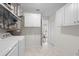 Clean and functional laundry room with modern appliances, ample cabinet space, and bright natural light at 5101 Huntington Ne Cir, St Petersburg, FL 33703