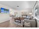 Open-concept living room with TV, dining room and view of the kitchen, plus light colored floors at 5101 Huntington Ne Cir, St Petersburg, FL 33703