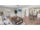 Bright, open-concept living and dining area with wood floors and contemporary furnishings at 5101 Huntington Ne Cir, St Petersburg, FL 33703