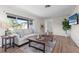 Cozy living room with sofa, coffee table, light floors and modern decor at 5101 Huntington Ne Cir, St Petersburg, FL 33703