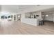 Open-concept living space with modern kitchen, light wood floors, and views of the waterfront canal at 5101 Huntington Ne Cir, St Petersburg, FL 33703