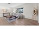Living room with sofa, coffee table, end table and view of the waterfront neighborhood at 5101 Huntington Ne Cir, St Petersburg, FL 33703