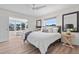 Bright primary bedroom boasts wood floors, access to lanai, and relaxing furnishings at 5101 Huntington Ne Cir, St Petersburg, FL 33703